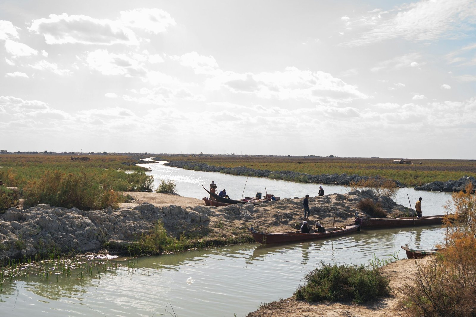 a group of people standing on top of a river